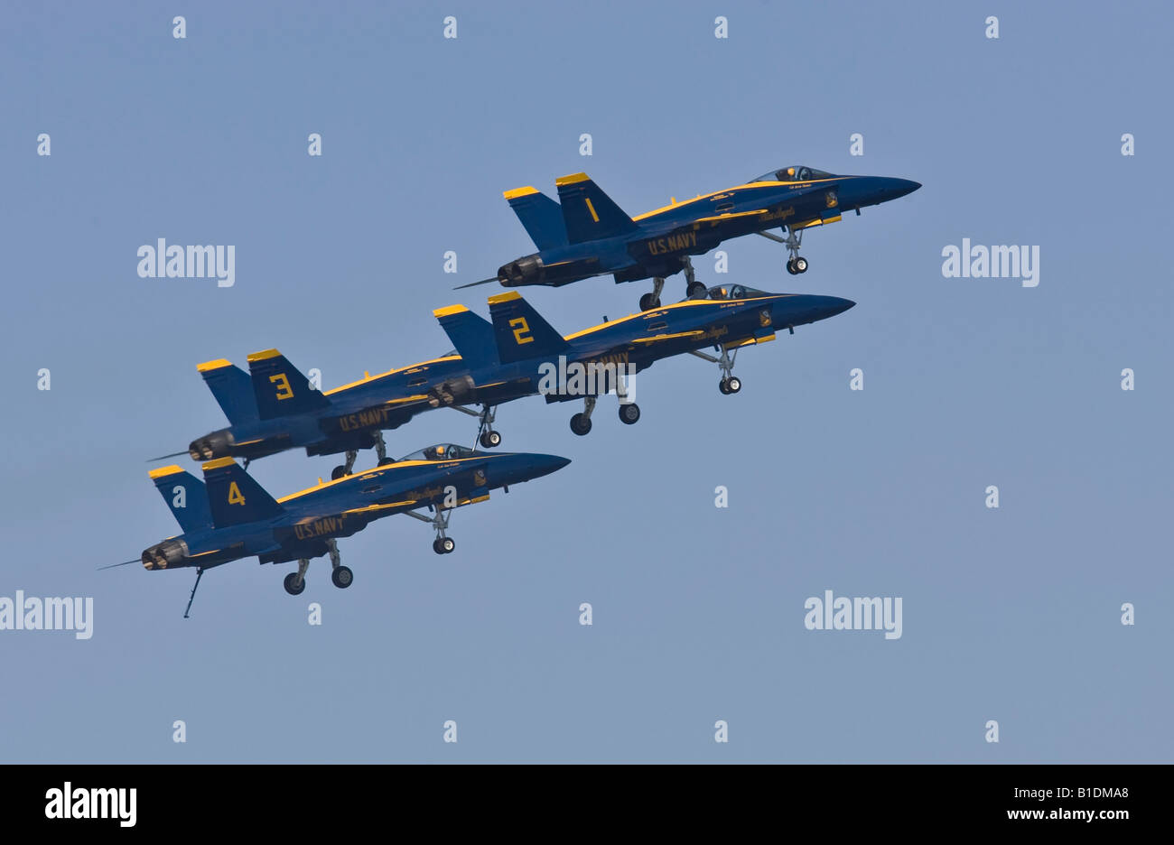 US Navy Blue Angels Flight Demonstration Squadron flying in formation with landing gear down Stock Photo
