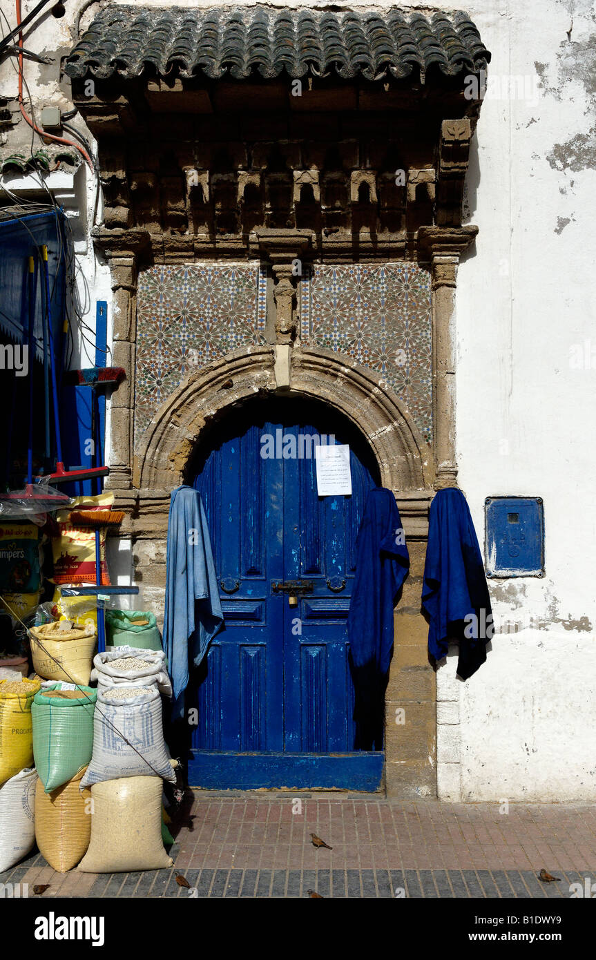 An inconic blue door in Essaouira in the old quater, with birds obtaining grain Stock Photo