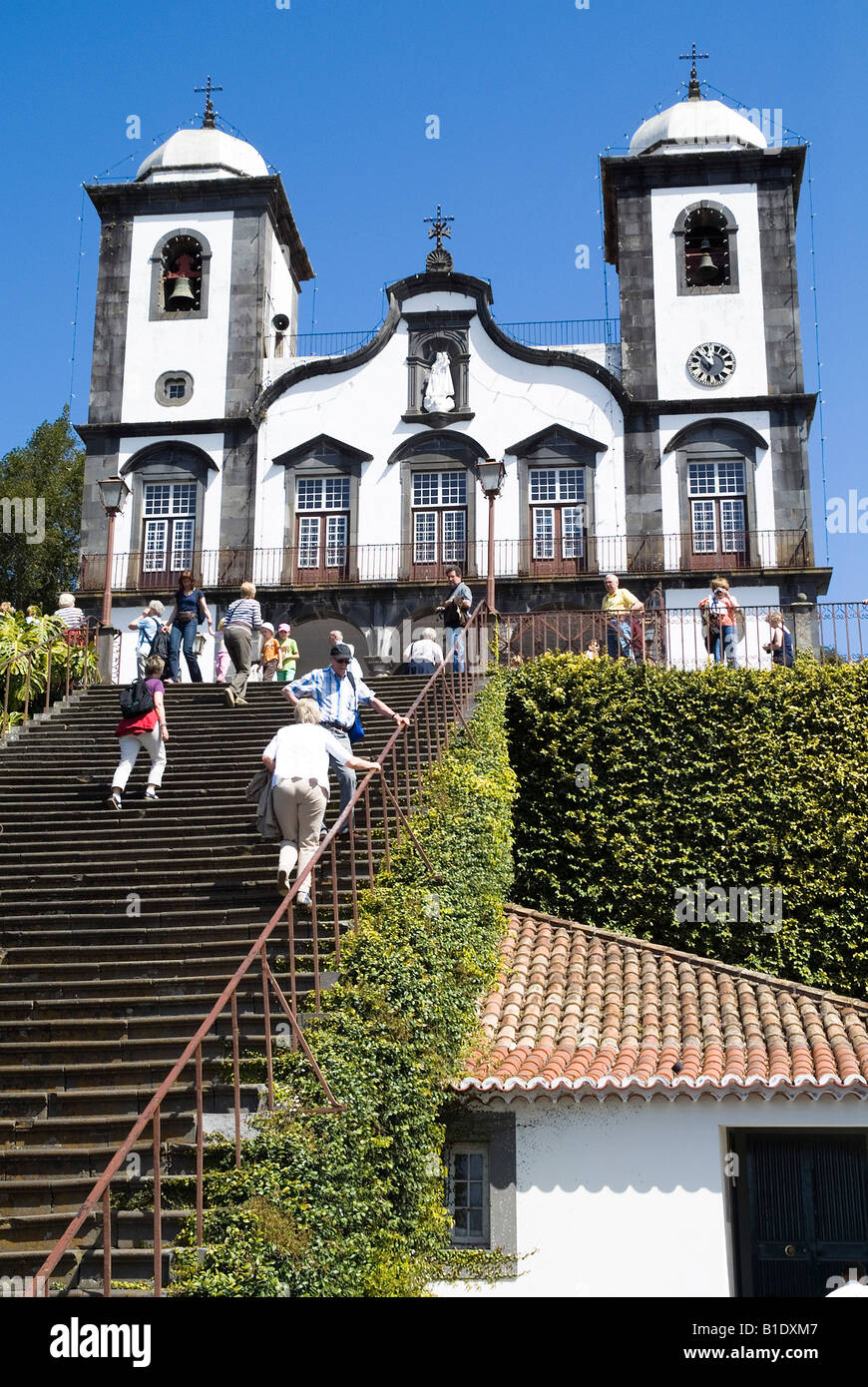 dh Church of Nossa Senhora MONTE MADEIRA Tourist climbing steps to Church of Our Lady people churches funchal visitors do holiday tourists Stock Photo