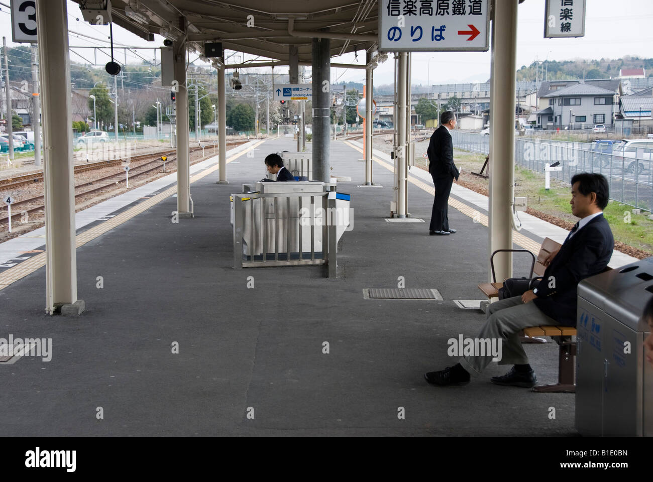 Kyoto, Japan. Passengers waiting for a train at a quiet suburban