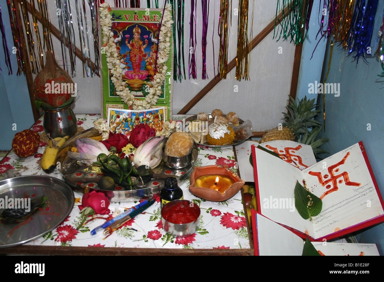 Shrine with offerings to the Hindu goddess Lakshmi for laxmi pooja during Diwali in the shop of a businessman , India Stock Photo