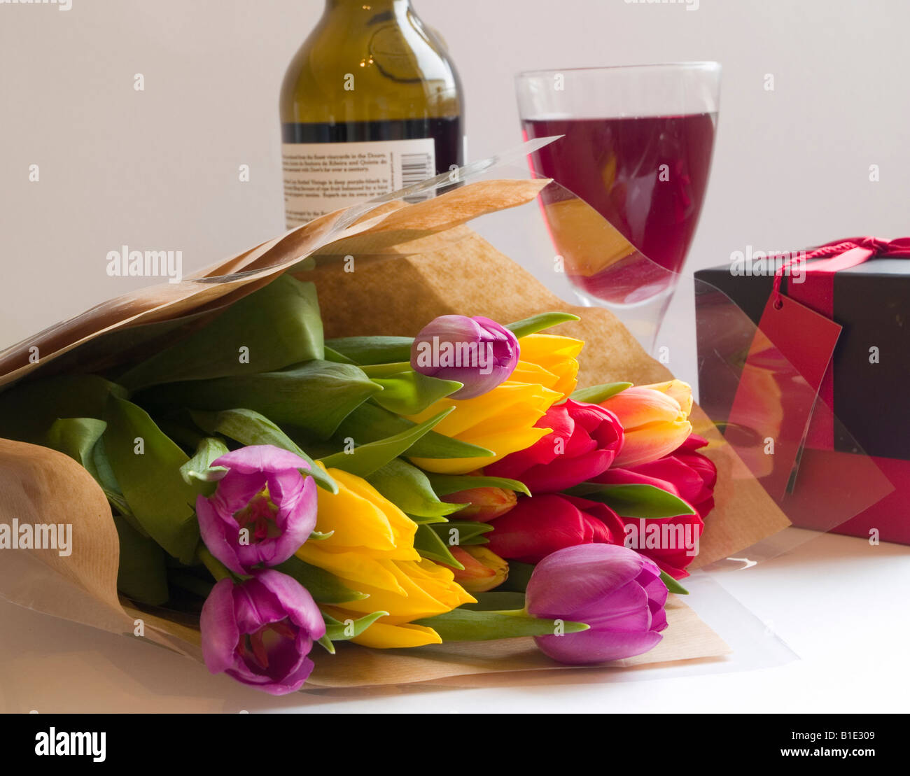 A Bunch Of Flowers A Glass And Bottle Of Wine And A Box Of Stock Photo Alamy