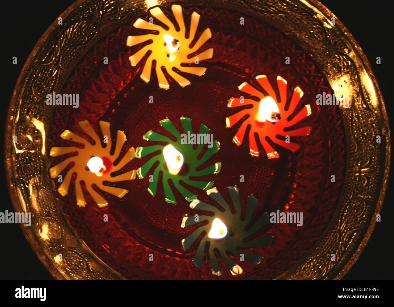 Small Diwali candles floating in a bowl outside a home during Diwali in