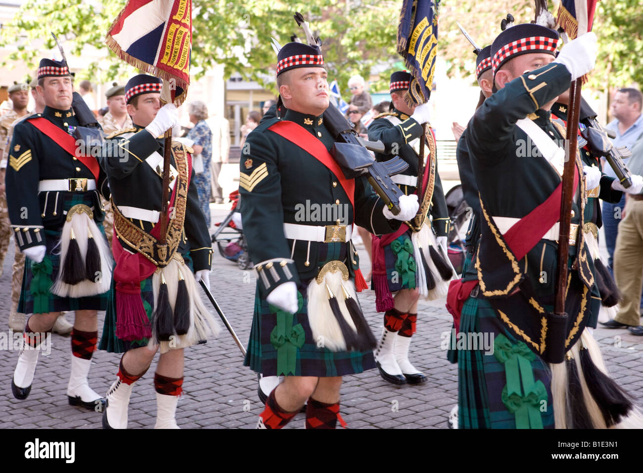 The Royal Regiment of Scotland marching through Dumfries town centre standard bearers and Scottish soldiers in kilts sporrans Stock Photo