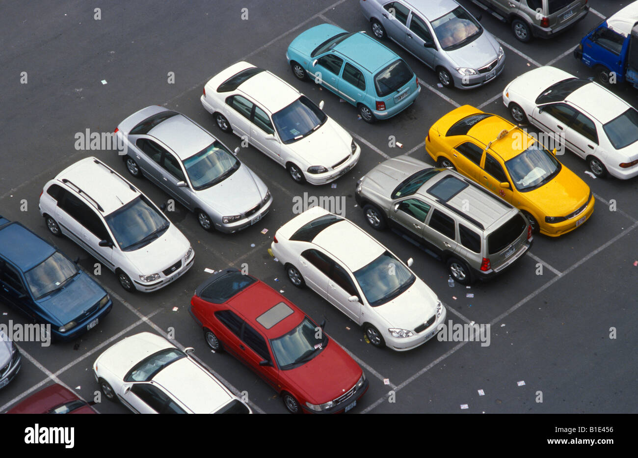 Close up of a full parking lot with fliers laying on the ground. Stock Photo