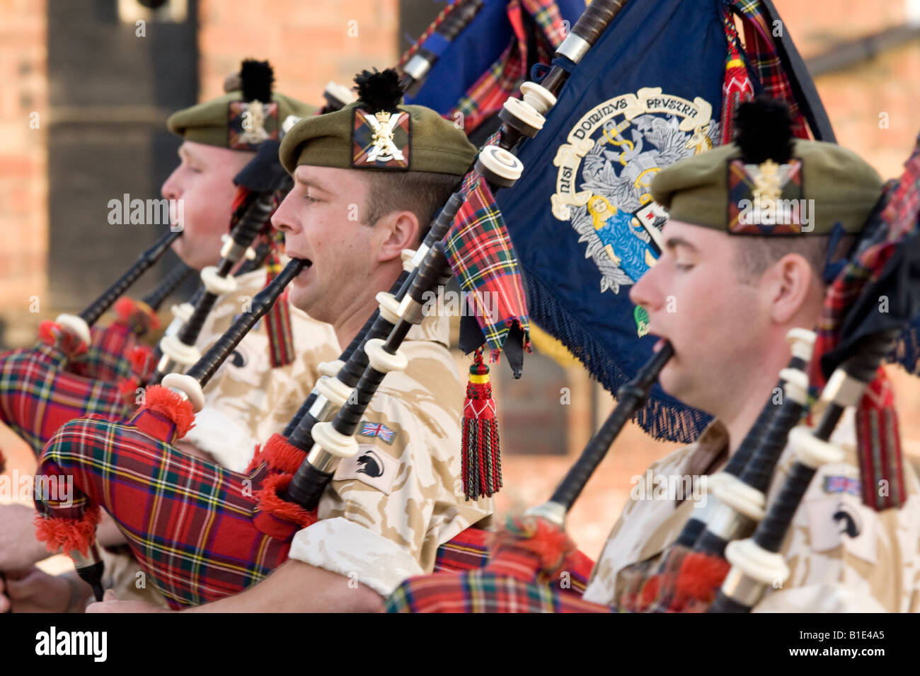 The Royal Regiment of Scotland military band soldiers bagpipers playing the pipes in desert fatigues in Dumfries Scotland UK Stock Photo