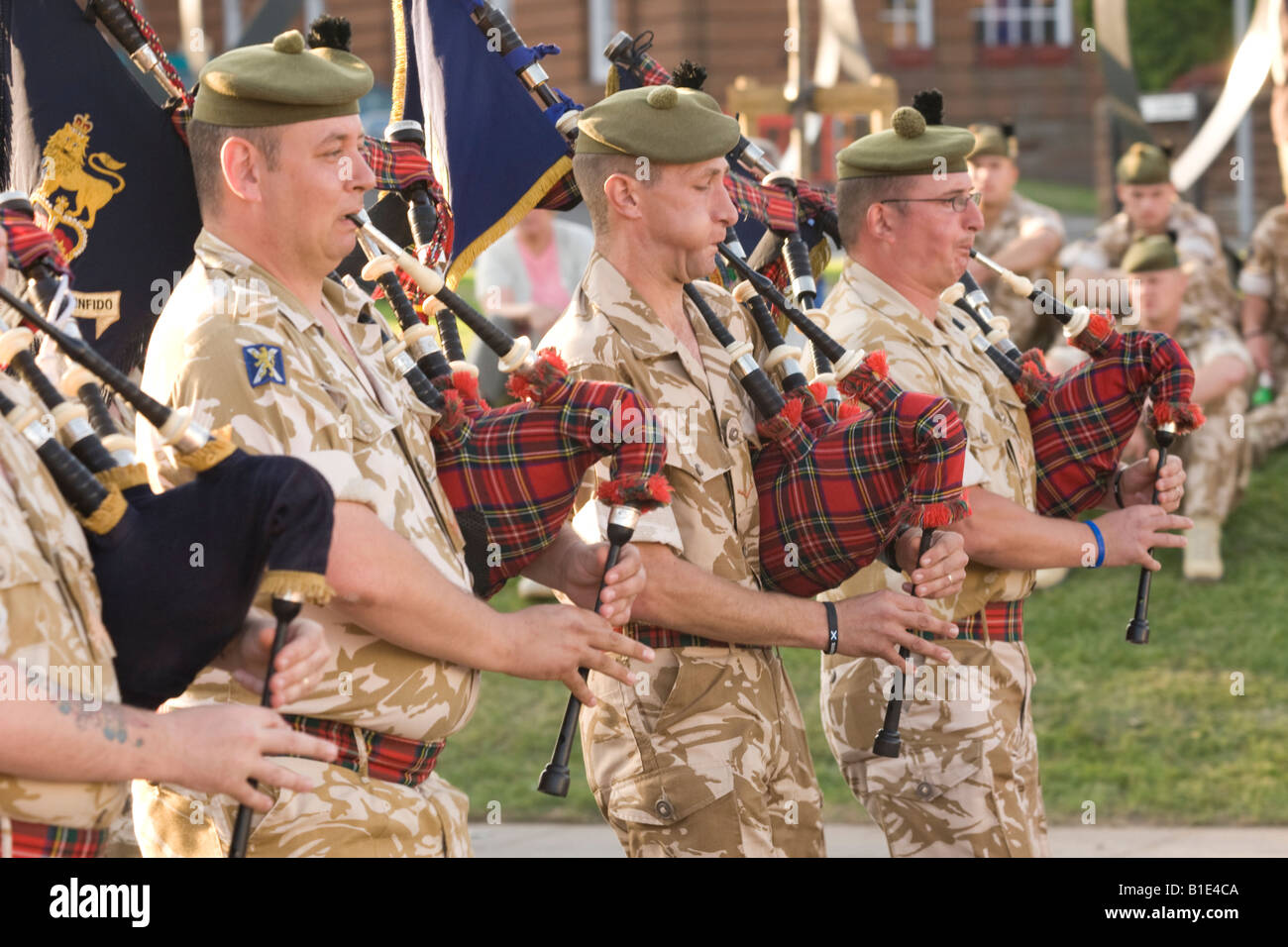 Scottish soldiers in military dress desert fatigues bagpipers beatiing the retreat Dumfries Scotland UK Stock Photo
