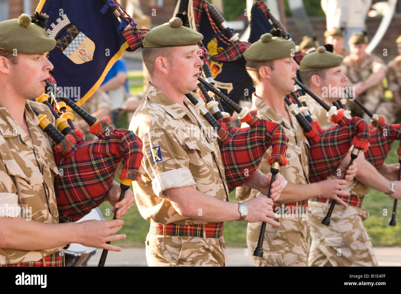 Military band bagpipers Scottish soldiers playing pipes Stock Photo