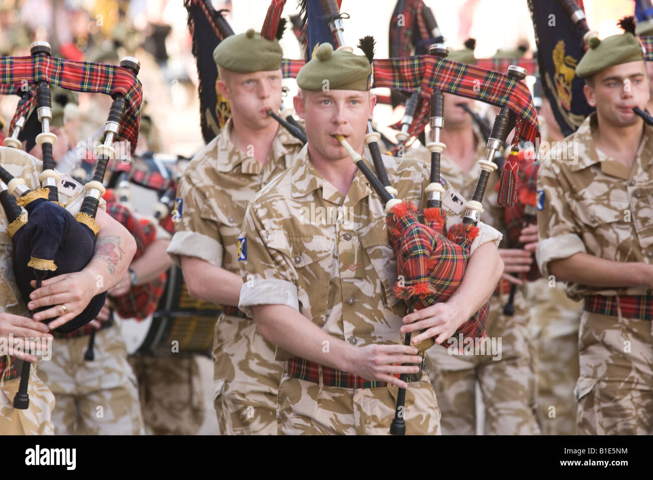 The Royal Regiment of Scotland marching through Dumfries town centre Scottish military army band bagpipers play pipes UK Stock Photo