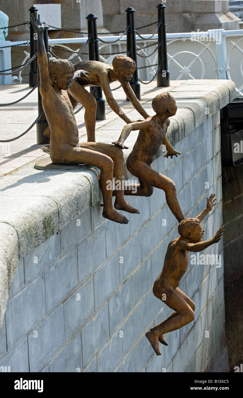 First Generation, a Sculpture of Five Boys Leaping into the Singapore River near Cavenagh Bridge in Singapore Stock Photo
