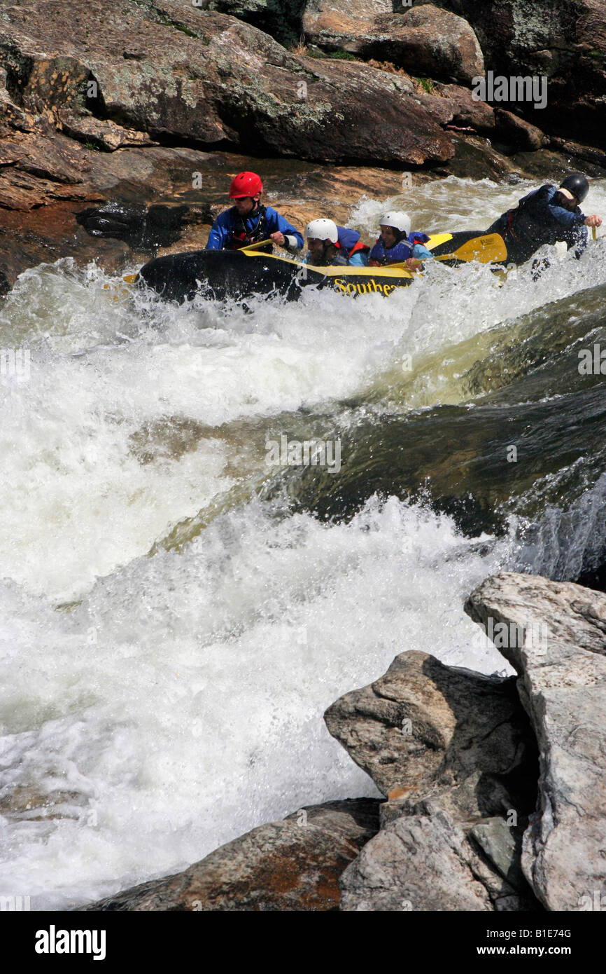 A family of whitewater rafters rides through the Bull Sluce on the Chattooga River between South Carolina and Georgia Stock Photo