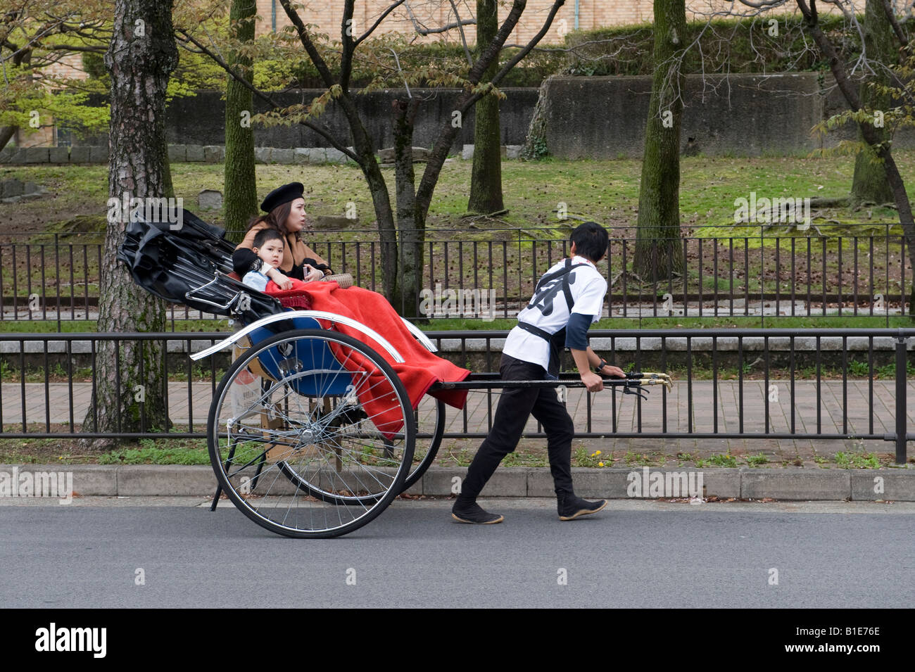 Kyoto, Japan. A mother and her small son travelling in a rickshaw Stock Photo