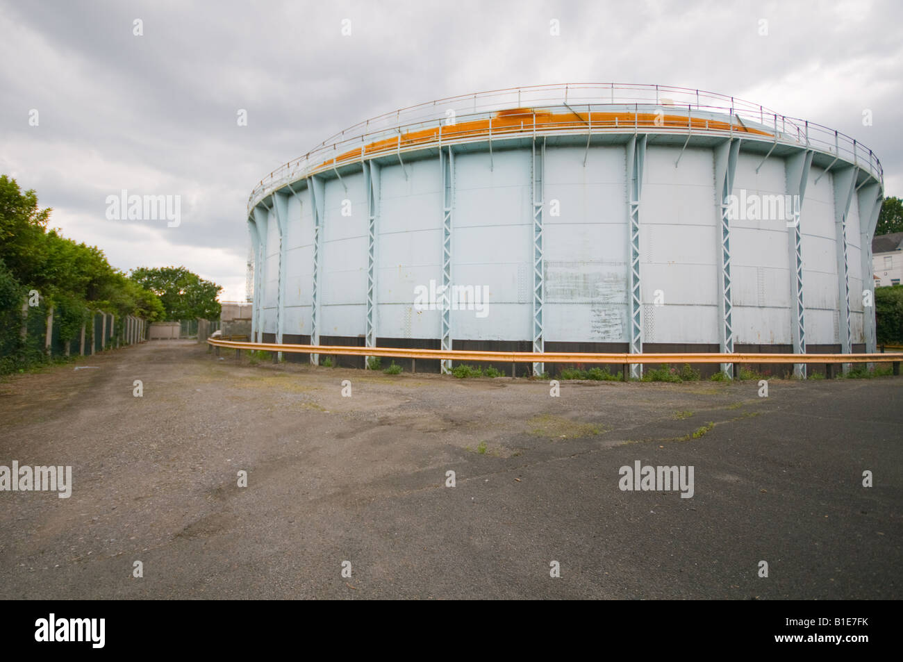 A gasometer partially empty during summer Stock Photo - Alamy