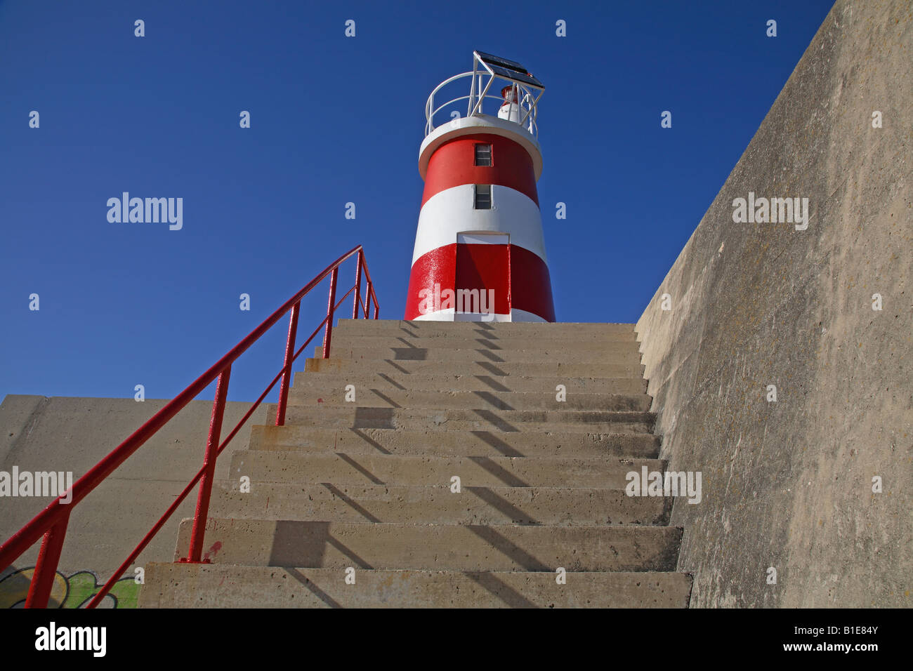 Red and white lighthouse at Baleeira fishing port, Sagres, Portugal Stock Photo