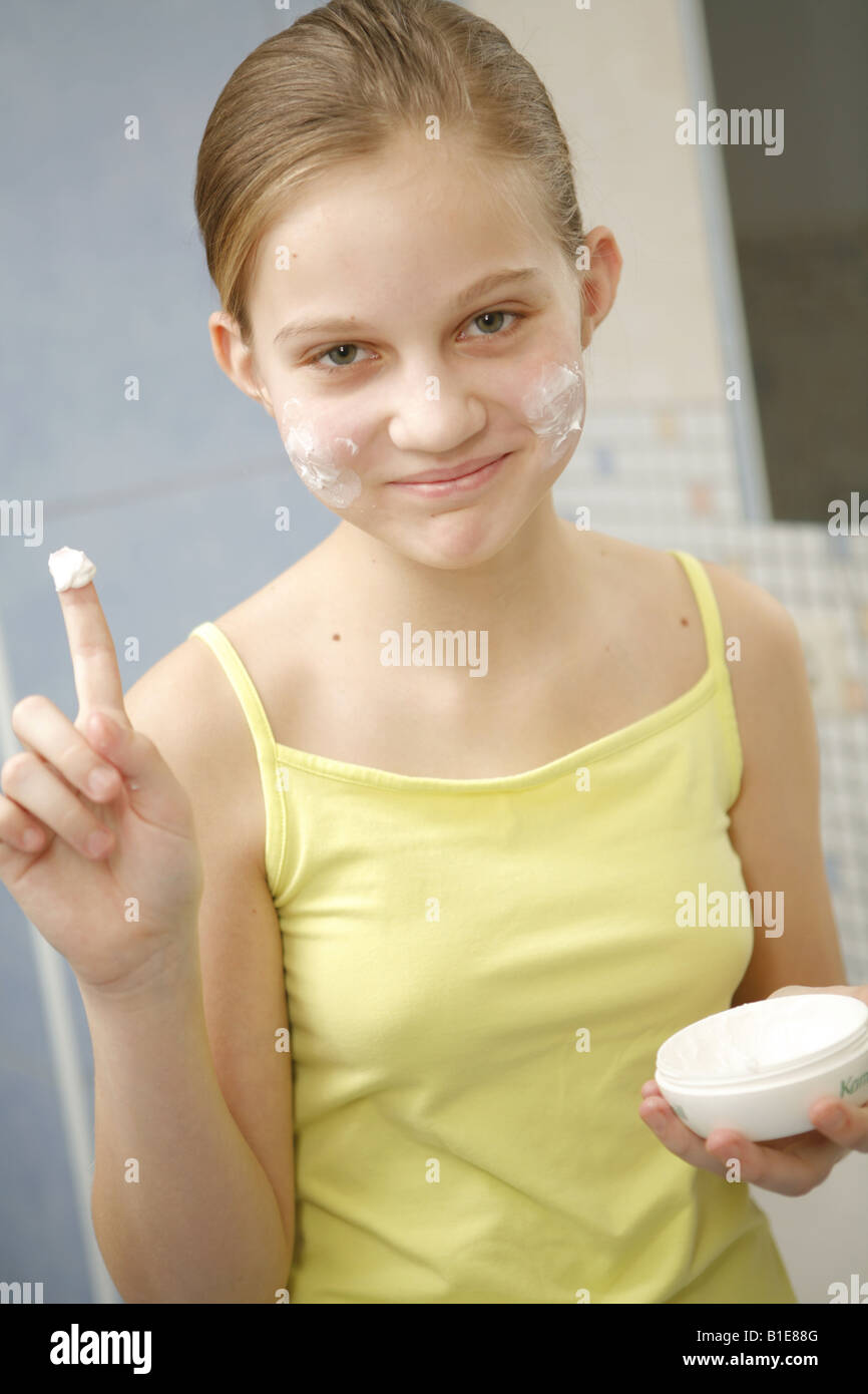 Preteen girl creaming face Stock Photo Alamy