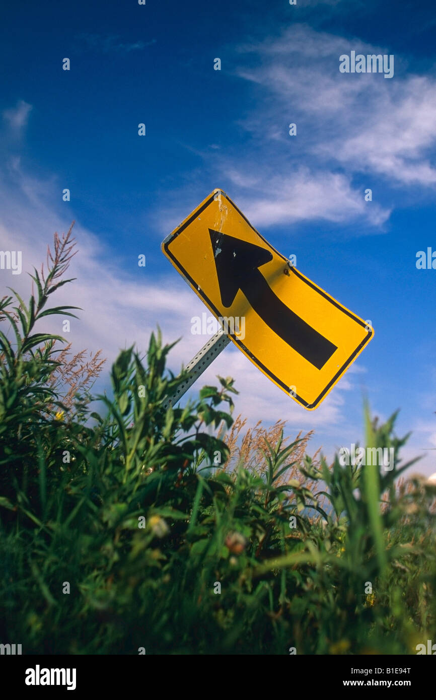 View of damaged road sign in grass USA Summer Stock Photo