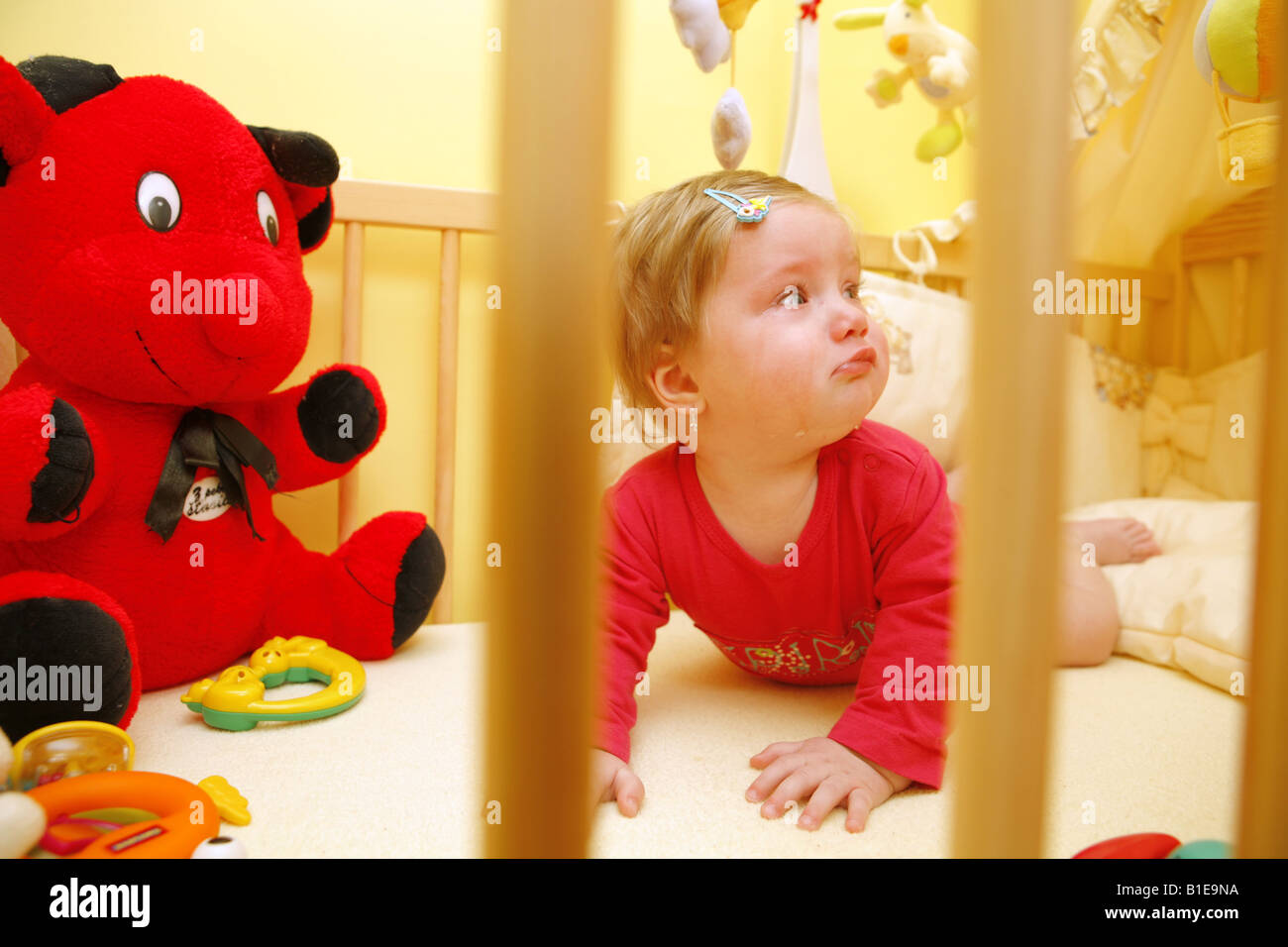 Baby toddles in baby bed Stock Photo Alamy