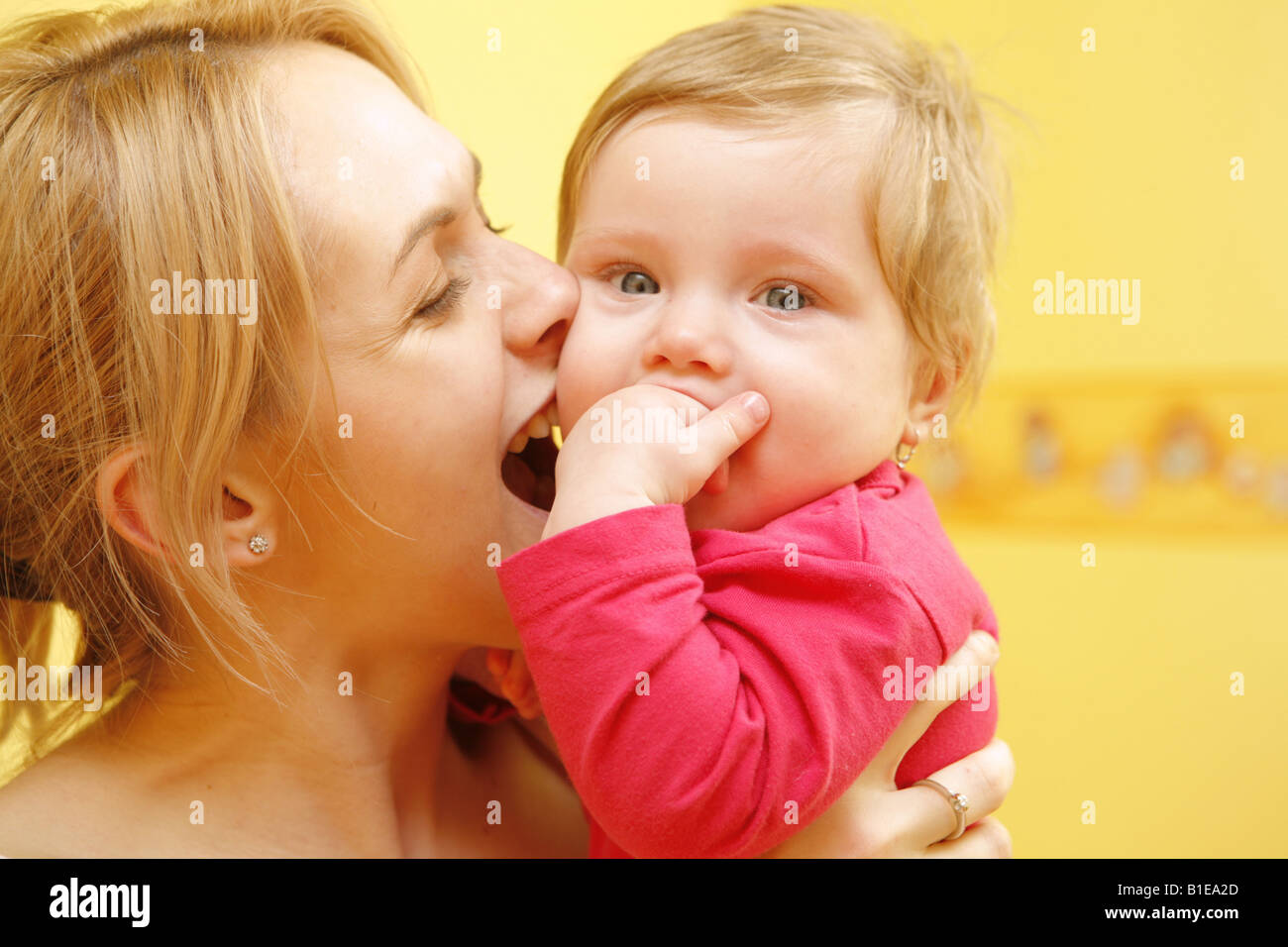 Mother bites baby Stock Photo Alamy