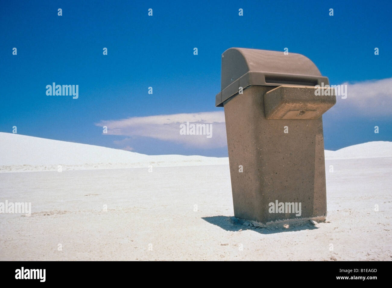 Concrete trash can in the middle of sand dunes White Sand Dunes national Monument New Mexico USA Stock Photo