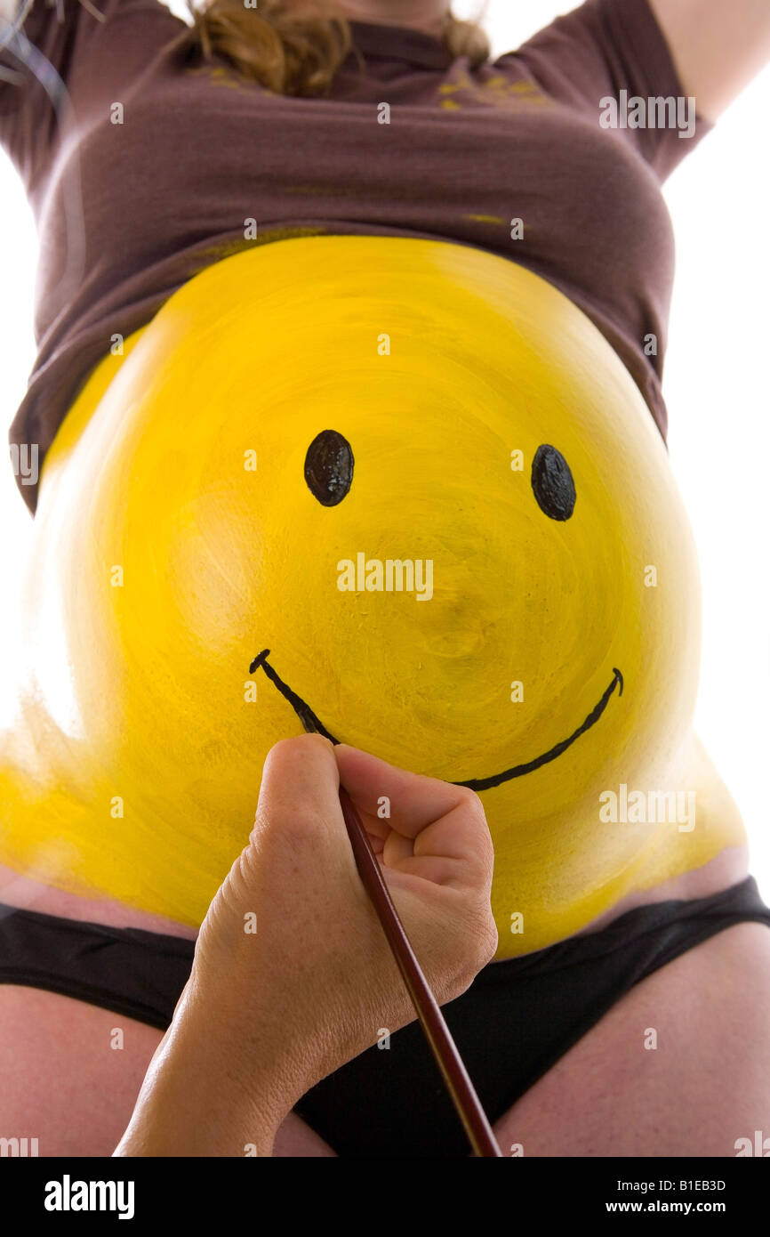 Download View Of Pregnant Woman S Stomach As A Yellow Smiley Face Is Being Stock Photo Alamy PSD Mockup Templates