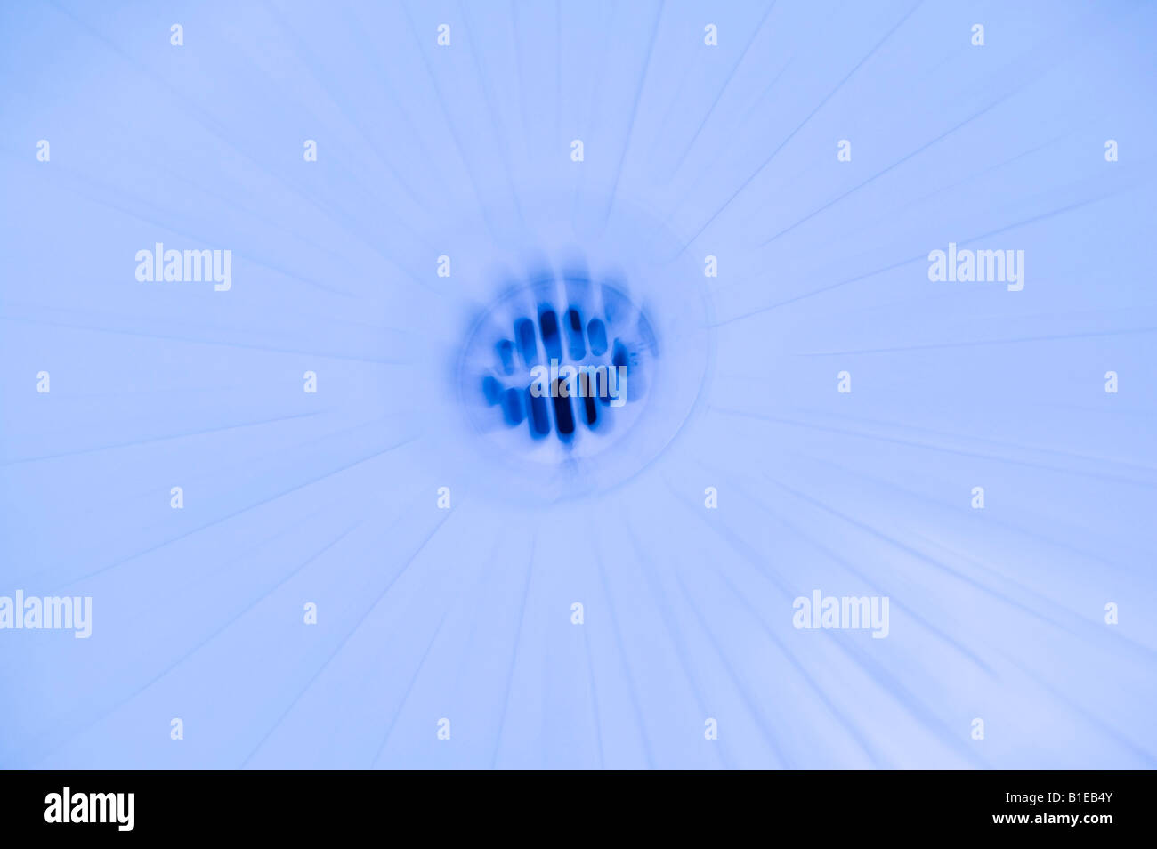 Blurred image of shower drain in blue light USA Stock Photo
