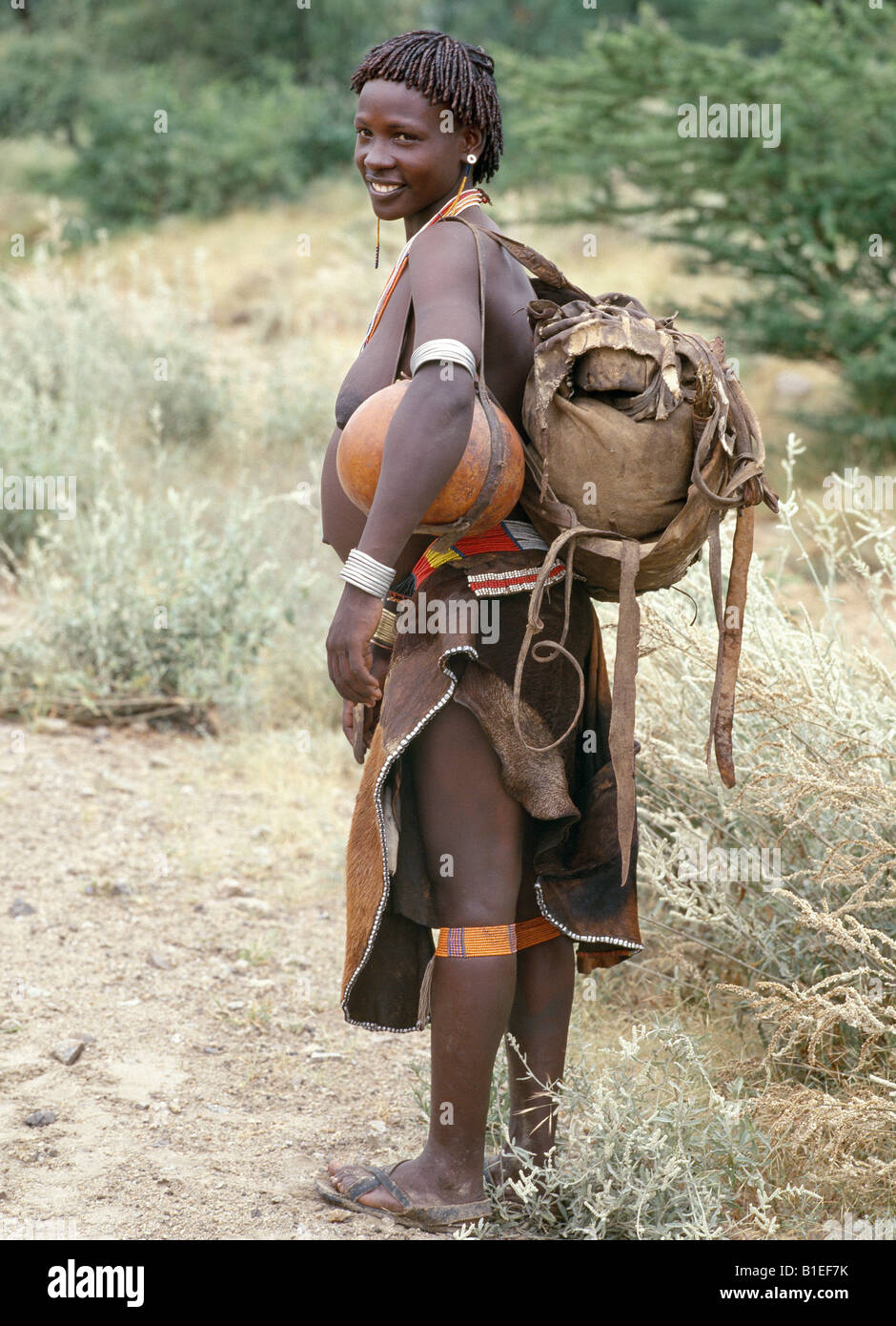 A woman of the Tsemay tribe of remote Southwest Ethiopia wears an attractively decorated leather skirt and apron. Stock Photo