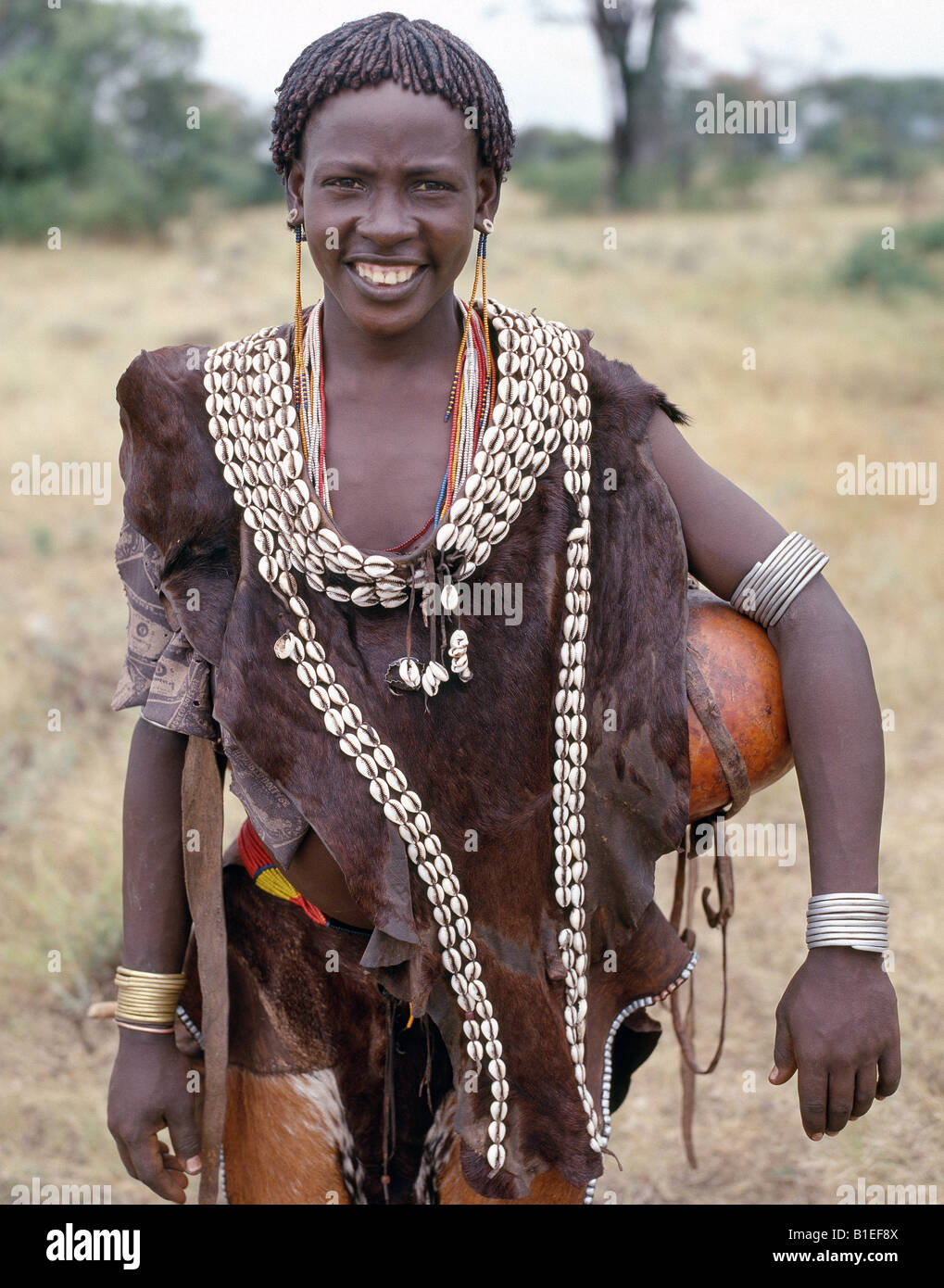 A woman of the Tsemay tribe of remote Southwest Ethiopia wears attractively decorated leather clothes. Stock Photo