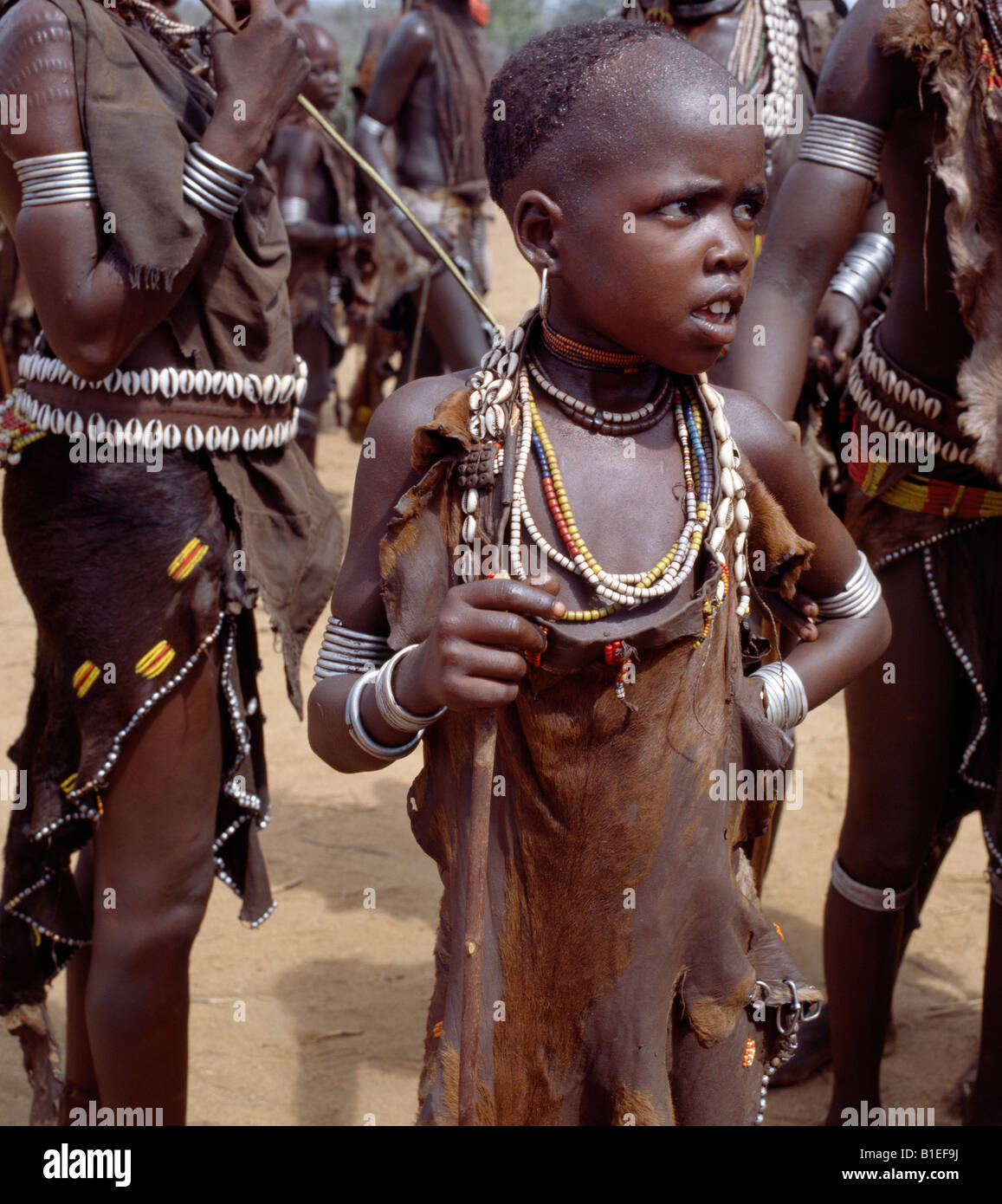 A young Hamar girl watches the proceedings during during a 'Jumping of the Bull' ceremony. Stock Photo