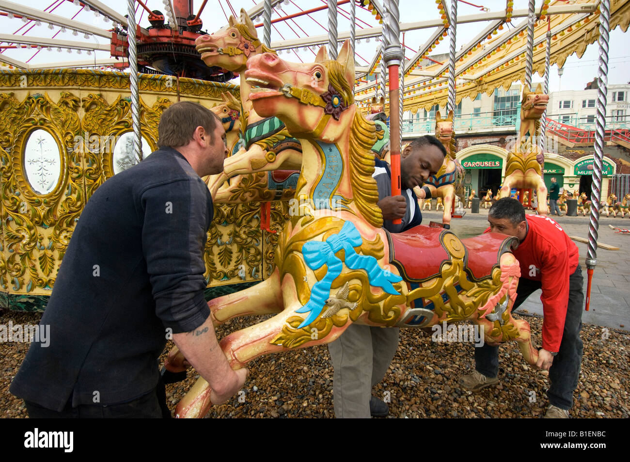 Fairground workers assembling the horses for Owen Smith and Son's Carousel on the Brighton sea front ready for the new season Stock Photo