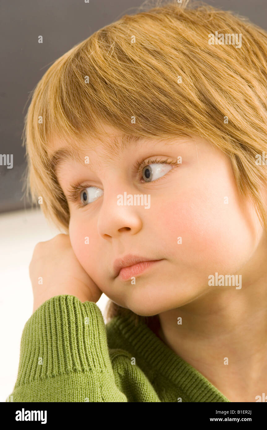Close-up of a boy thinking Stock Photo - Alamy