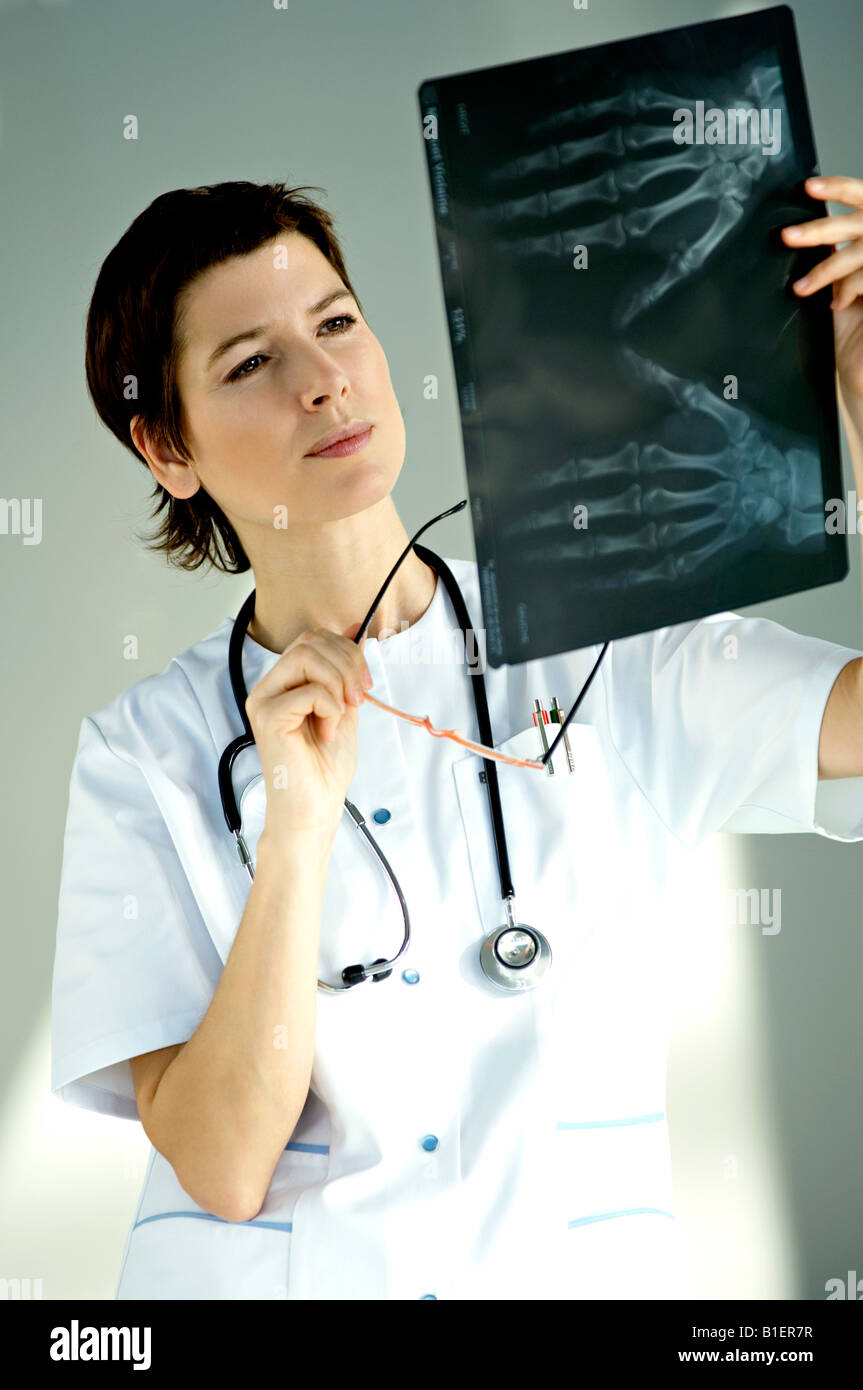 Female Doctor Examining An X Ray Report Stock Photo Alamy