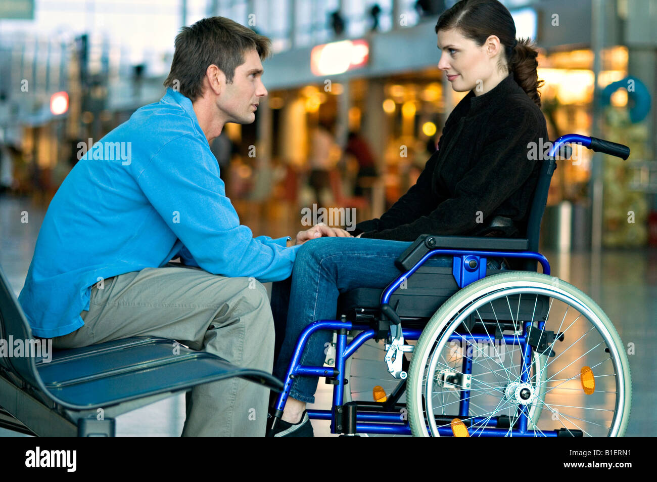 Side profile of a mid adult man talking with a young woman Stock Photo ...