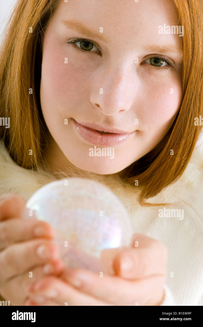 Woman holding up crystal ball hi-res stock photography and images - Alamy
