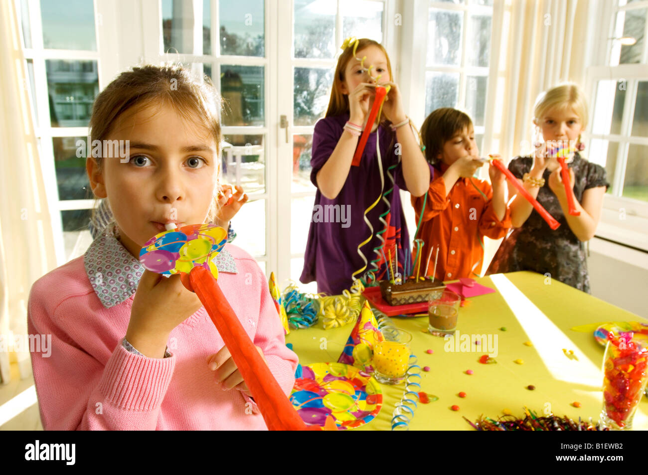 Children blowing horn blowers in a party Stock Photo - Alamy