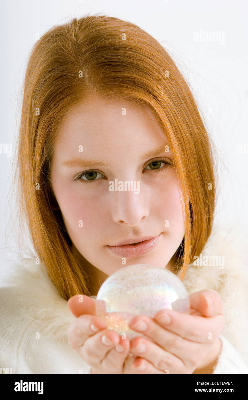 Woman holding up crystal ball hi-res stock photography and images - Alamy
