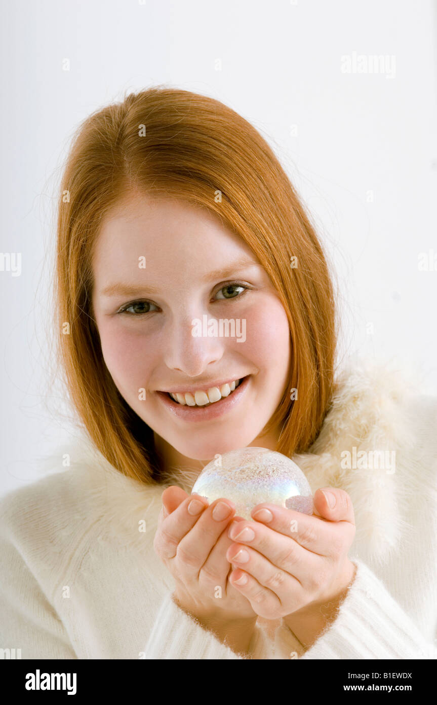 Portrait of a young woman holding a crystal ball and smiling Stock ...