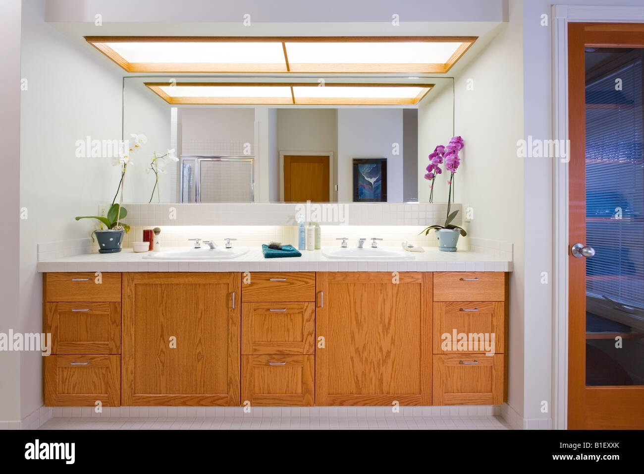 View of a bathroom & vanity of a contempory residence with maple woodwork, Anchorage Alaska. Stock Photo