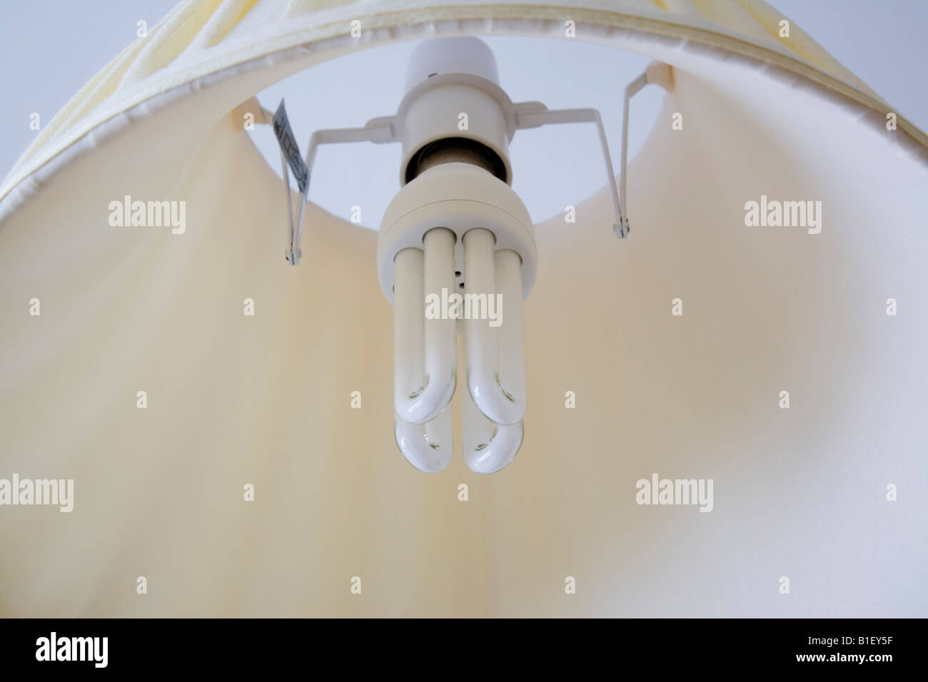 Energy efficient light bulb in ceiling lamp with lampshade Stock Photo