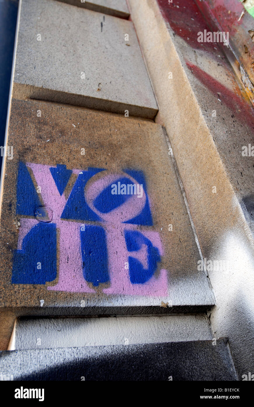 A stencil on a wall of a building on the Bowery in New York exhorts passerby to vote Stock Photo