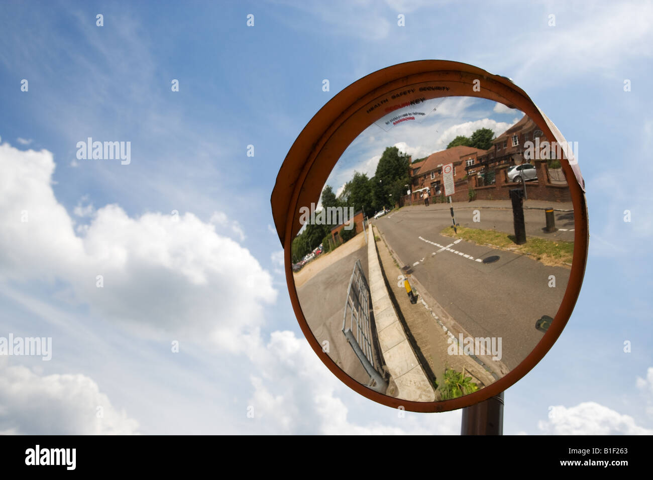 A convex mirror used as a hazard warning traffic safety device. Stock Photo