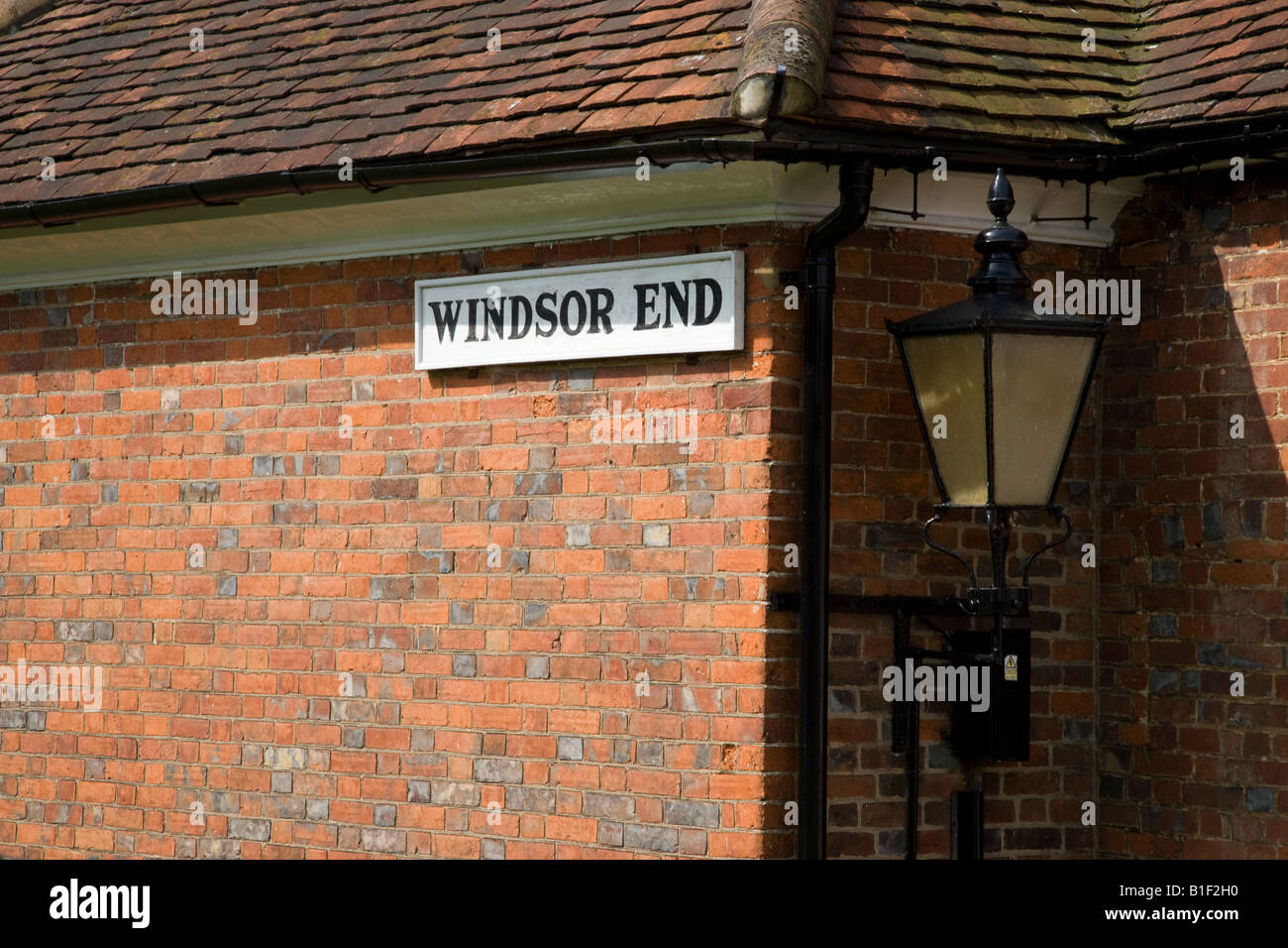 street sign and place name on the side of a traditional red brick built wall of a house in Beaconsfield Bucks UK Stock Photo