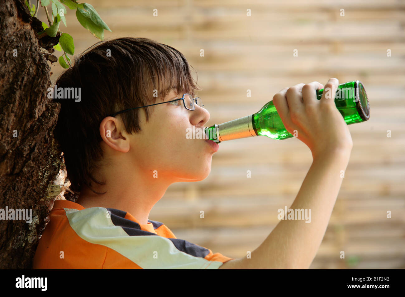posed portrait of a young boy drinking beer Stock Photo Alamy