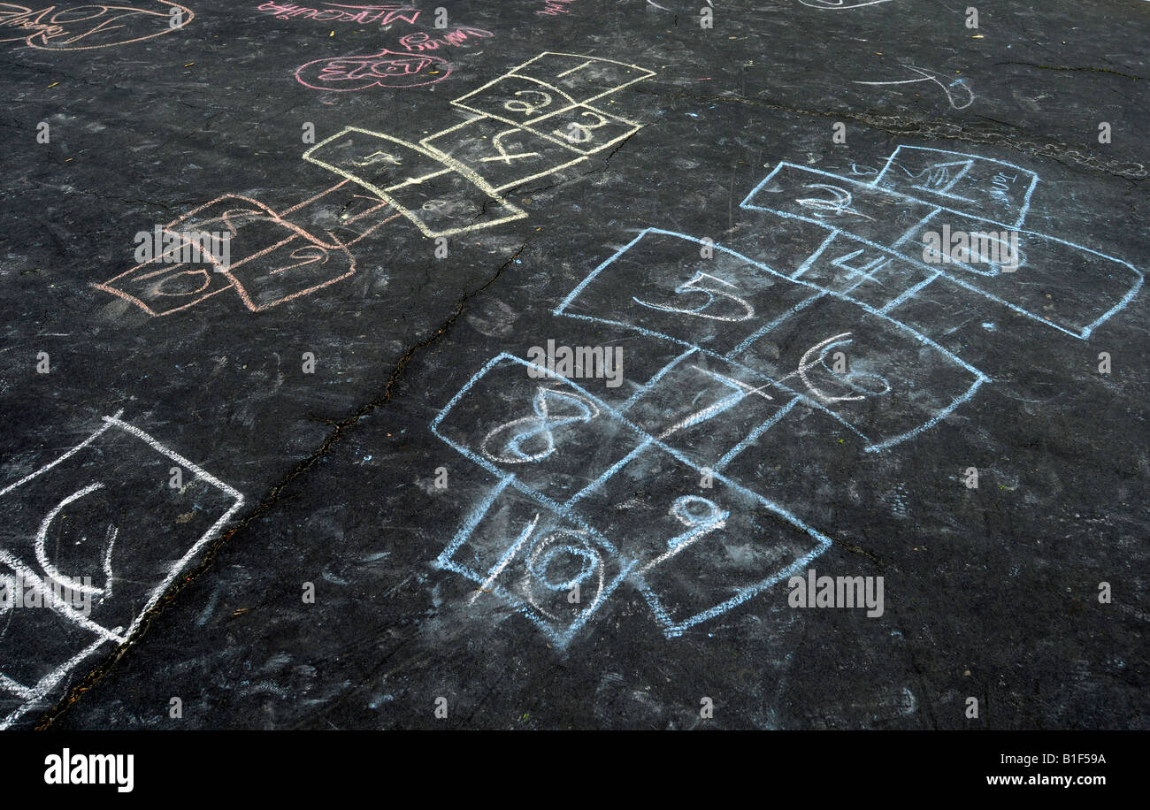 Hopscotch games drawn in colored chalk on a parking lot Stock Photo Alamy