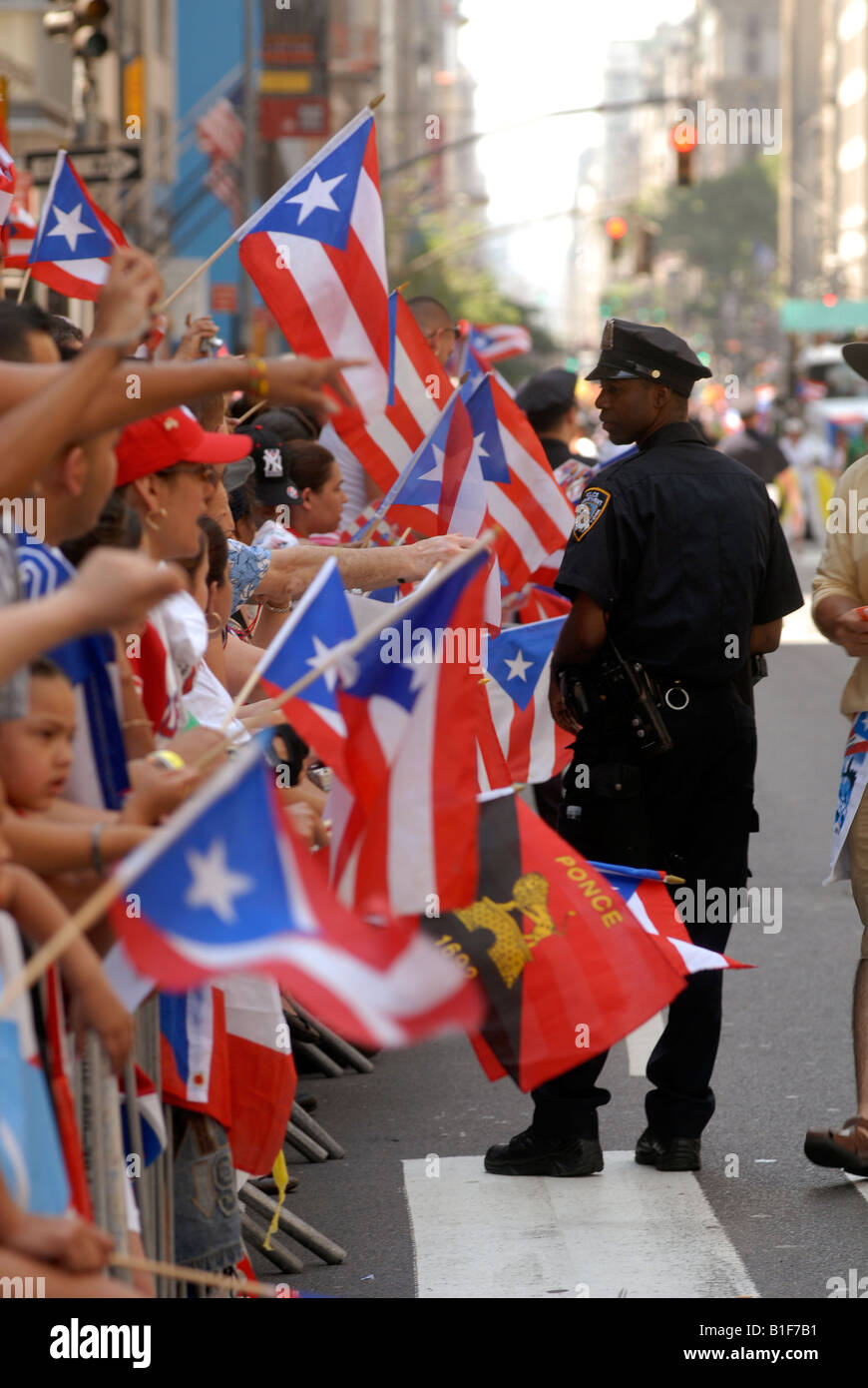 Police watch spectators at the 13th Annual National Puerto Rican Day Parade in New York on Fifth Avenue Stock Photo
