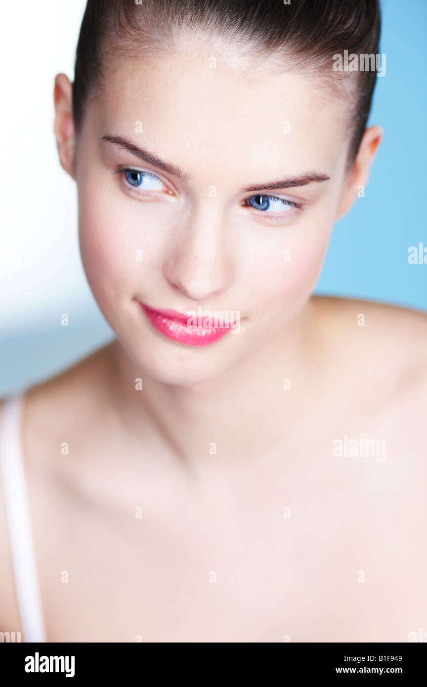Portrait of young woman looking away Stock Photo - Alamy