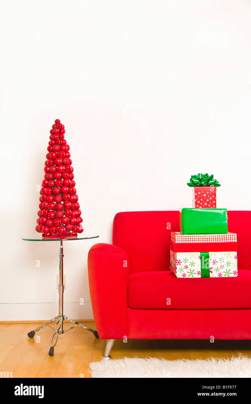 Stack of Christmas gifts on sofa Stock Photo