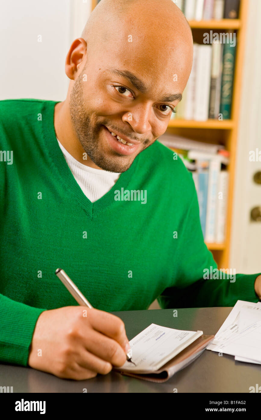 Man Write Check African man writing check Stock Photo - Alamy