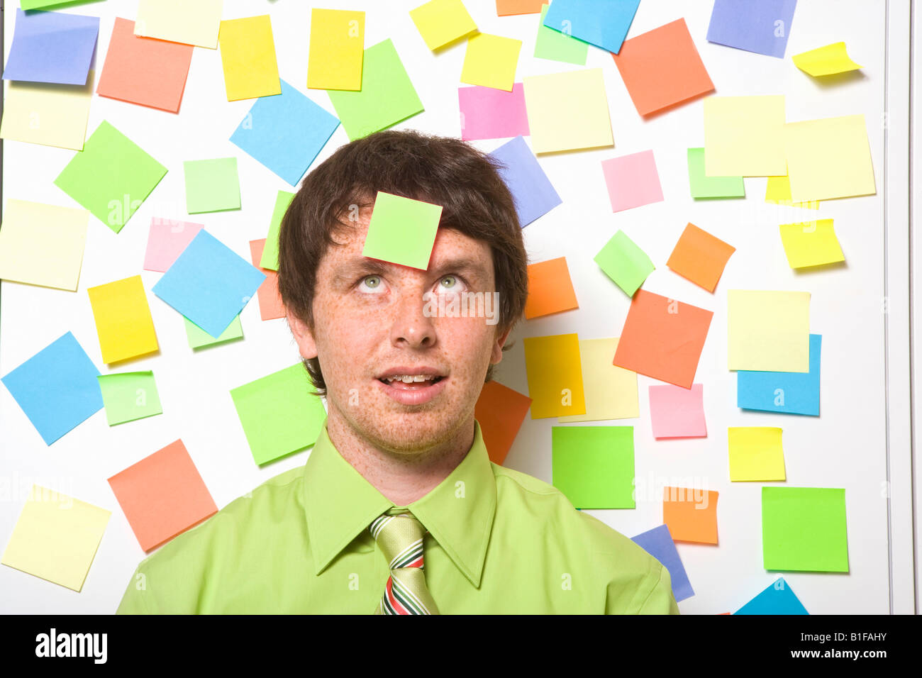 Businessman with adhesive note on forehead Stock Photo