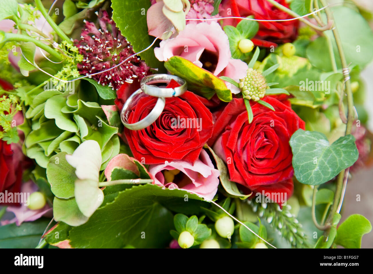 Wedding rings on flower bouquet Stock Photo Alamy