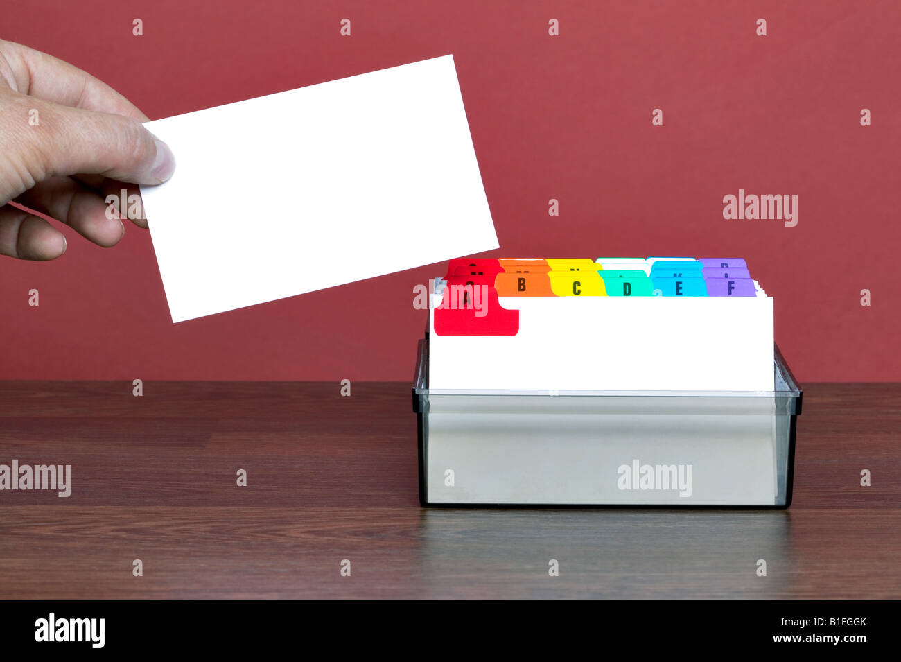 A blank card being pulled out from a file index insert your own contact details Stock Photo